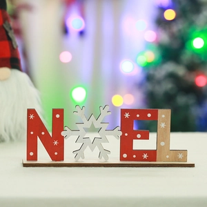 Detail of wooden Noel letter block with snowflake patterns for Christmas table decor