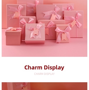 Detailed view of pink gift boxes with satin ribbons and elegant hanging tags