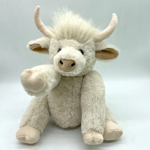 Detailed close-up of fluffy cream-colored highland cow plush with soft textured faux fur
