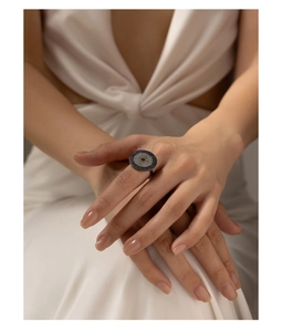 Detail of S925 silver ring featuring a blue and white evil eye pattern on a hand