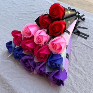 Close-up of colorful soap rose bouquets in elegant cone-shaped gift wraps with ribbons