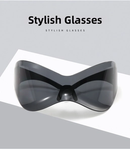 Detail of futuristic Y2K oversized one-piece sunglasses with dark grey lenses and sleek frame