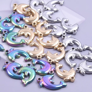 Macro shot of stainless steel dolphin pendants in gold, silver and iridescent finishes