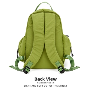Back view of green nylon backpack showing padded shoulder straps and side zipper pockets