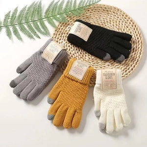 Close-up of knit touch screen gloves in four colors with thick texture and tags