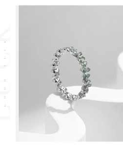 Detail of s925 silver flower ring with mint green enamel and sparkling crystals