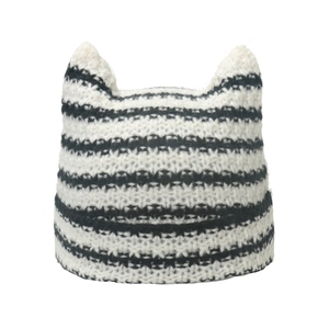 Cute black and white striped knitted beanie with cat ears on a clean white background