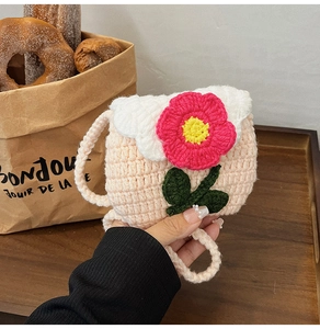 Detail of a handmade crochet flower pouch in pink and white for coins and earphones