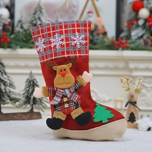 Detail of red Christmas stocking with reindeer plush and festive white snowflake appliques