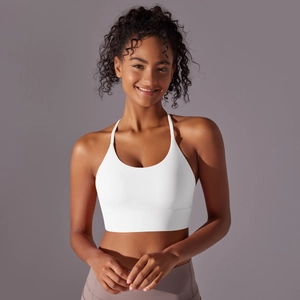 Detail of white halter neck yoga bra showing thin straps and wide ribbed support band