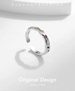 Macro shot of S925 sterling silver ring featuring colorful zircon stones and wave texture