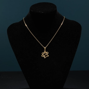 Gold-plated stainless steel paw print necklace on black display stand for women