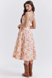 Detail view of pink and yellow floral sleeveless midi dress with a stylish back slit