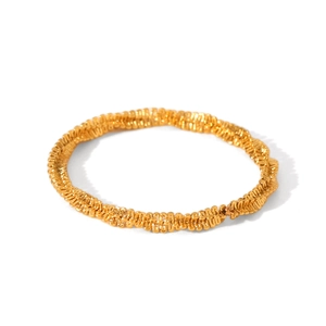 Close-up of golden stainless steel ring featuring detailed twisted spiral textures