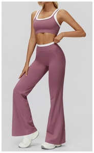Detail view of pink flared yoga pants with white contrast piping and breathable fabric