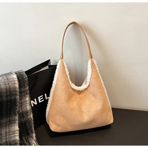 Close-up of contrast tote bag featuring khaki suede texture and soft white faux shearling trim