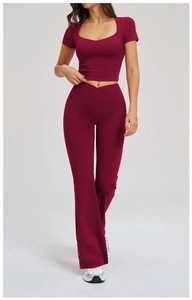 Detailed view of high-stretch burgundy yoga set with U-neck crop top and flared leggings
