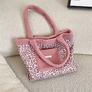 Close-up of leopard print canvas tote with pink fleece pocket and Sorakka brand label