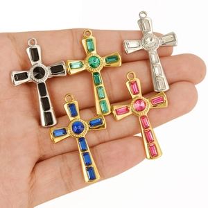 304 stainless steel cross necklaces with colorful crystals held by a model on white background