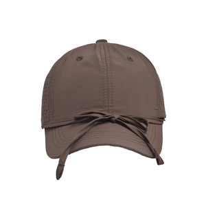 Detail view of brown quick-dry baseball cap with bow tie decor and breathable laser holes