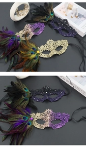 Detail of masquerade lace mask with gradient feathers and intricate rhinestone accents