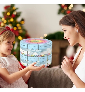 Close-up of light blue double-layer cake-shaped gift box with decorative ribbon bow