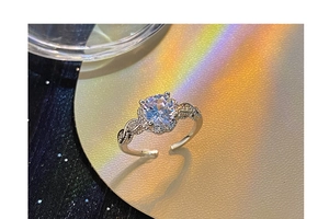 Macro view of adjustable flower ring with cubic zirconia and vine braided band