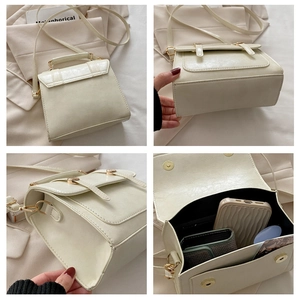 Detailed views of a cream faux leather handbag with gold hardware and top handle