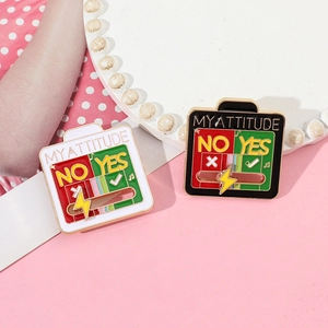 Macro detail of interactive enamel sliding pin showing 'MYATTITUDE' with yes no options