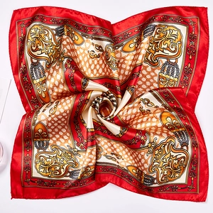 Detail of red and gold baroque print scarf with silk texture and chain motifs