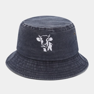Detailed embroidery of a cow head on vintage washed charcoal grey bucket hat