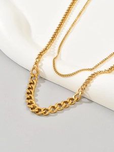 Detail of double-layer gold plated stainless steel necklace with thick Cuban chain link