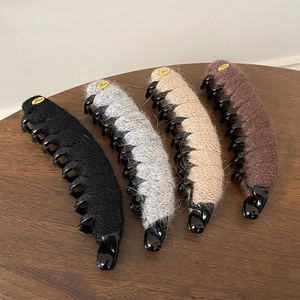 Set of four flocking yarn banana hair clips in neutral colors with gold Love accents