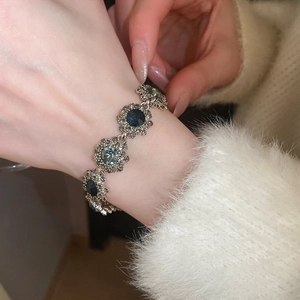 Close-up of vintage flower bracelet with blue-grey faceted stones on a female wrist