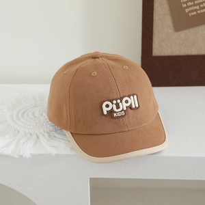 Detailed close-up of brown kids baseball cap with stitched logo and contrast brim