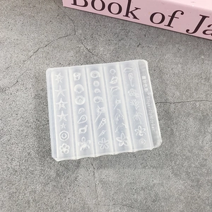 Detailed view of clear silicone nail art mold with starfish shell and palm tree patterns