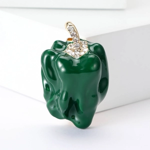 Green enamel chili brooch with gold-plated rhinestone stem on white background