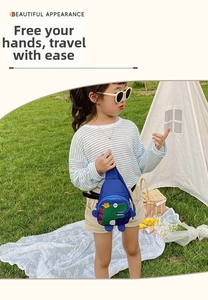 Kid's blue nylon dinosaur chest bag with adjustable strap worn by a child outdoors