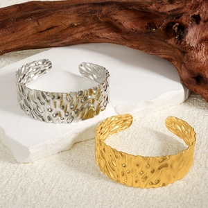 Textured 304 stainless steel open bangles in gold and silver with a hammer-finish design