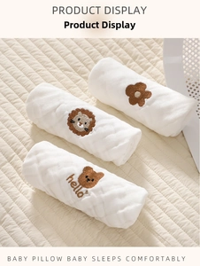 Detailed view of three white cotton gauze baby pillows with cute animal embroidery art