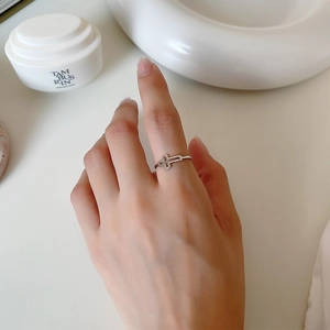 Minimalist S925 sterling silver hollow cross open ring shown on a finger in bright light