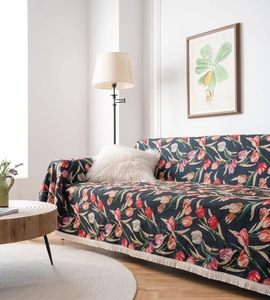 Detailed close-up of a floral tulip jacquard sofa throw cover with cream tassel edges