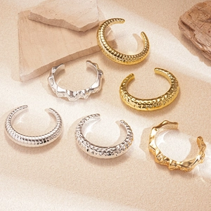 Irregular C-shaped acrylic bangles in gold and silver with various unique textures