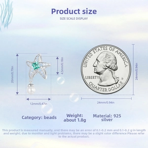 Detailed view of S925 silver starfish charm with green gemstone and white pearl detail