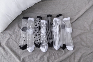 Flat lay of sheer mesh summer crew socks featuring various patterns like dots and hearts