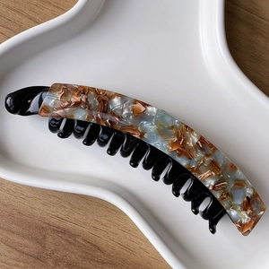 Detail of marble pattern banana hair clip with France Handmade gold lettering on tray