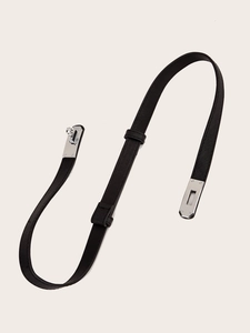 Close-up of black lychee grain leather skinny belt with a silver metal twist lock buckle