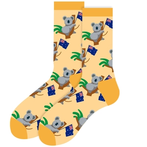 Detail of yellow crew socks featuring grey koala and Australian flag patterns in layout