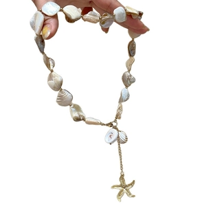 Ocean style necklace set with natural shell fragments and golden starfish pendants
