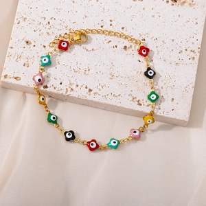 Detail of colorful flower charms with evil eye motifs on a gold adjustable chain